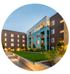 A well-maintained apartment complex with a clean outdoor space, showcasing the benefits of commercial poop scooping services.