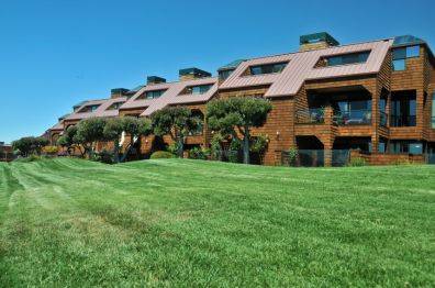 A clean and well-maintained commercial property with lush green grass, showcasing the benefits of commercial poop scooping services.