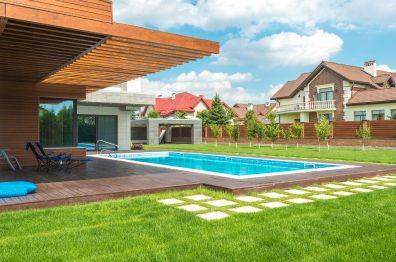 A clean and fresh backyard with a swimming pool, highlighting the benefits of Swoop Champ's odor control solutions.
